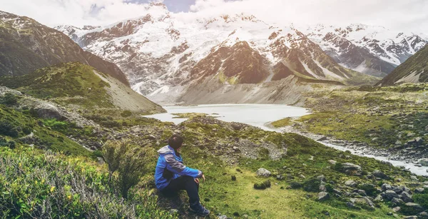 Mountain hiker traveling in wilderness landscape of Mt Cook National Park. Mt Cook, the highest mountain in New Zealand, is known for outdoor travel trekking inspiration, mountain journey.