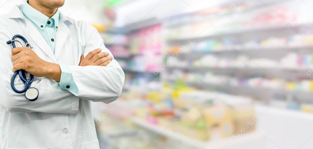 Male pharmacist standing in drugstore pharmacy.