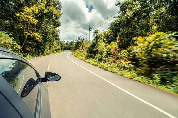 Orman karayolunda yolda araba sürme yan görünümü — Stok fotoğraf