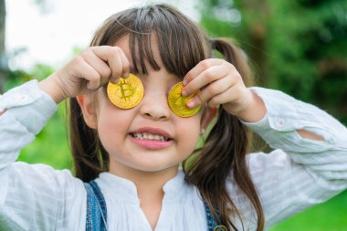 Bitcoin dijital para tutan küçük kız çocuk.