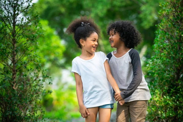 Happy little boy and girl in the park. — Stock Photo, Image