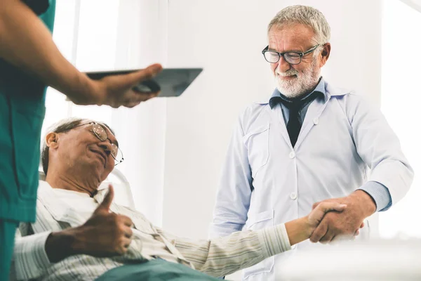 Médico maduro y paciente sénior en la sala de hospital . — Foto de Stock