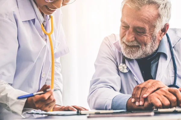 Senior medico di sesso maschile che lavora con un altro medico . — Foto Stock