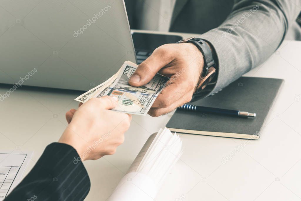 Transfer of money from hand to hand.