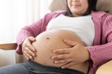 Mutlu hamile bir kadın ve evde bebek bekliyor..