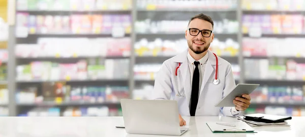 Pharmacist using tablet computer at pharmacy. — Stock Photo, Image