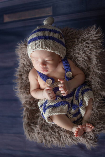 Adorable newborn baby sleeping in cozy room.