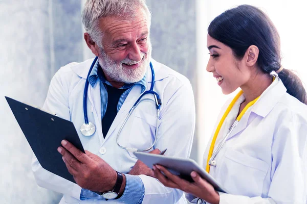 Doctors working with tablet computer at hospital. — Stock Photo, Image