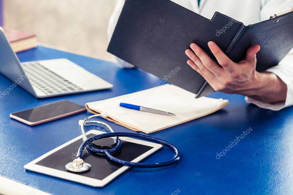 Doctor working in hospital office.