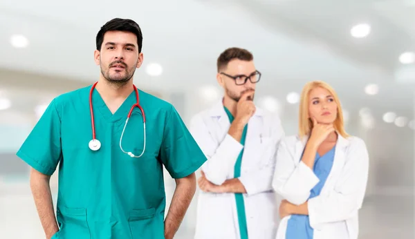 Médico que trabalha no hospital com outros médicos . — Fotografia de Stock