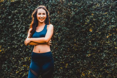 Genç spor kadını parkta sabah egzersizi yapıyor.