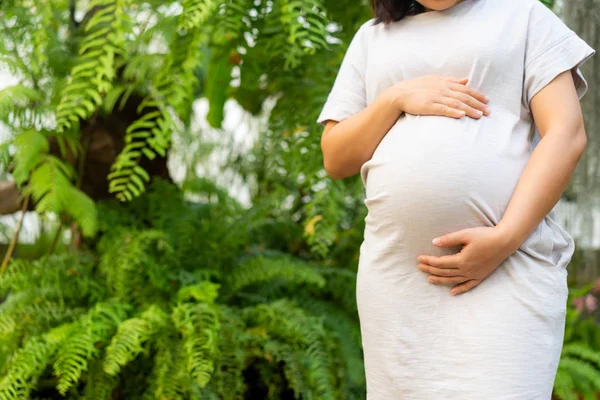 Happy pregnant woman and expecting baby at home.