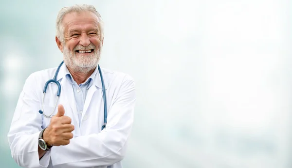 Happy senior doctor standing in the hospital. Stock Image