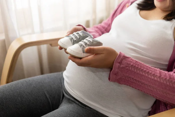 Mujer embarazada feliz y esperando un bebé en casa. — Foto de Stock