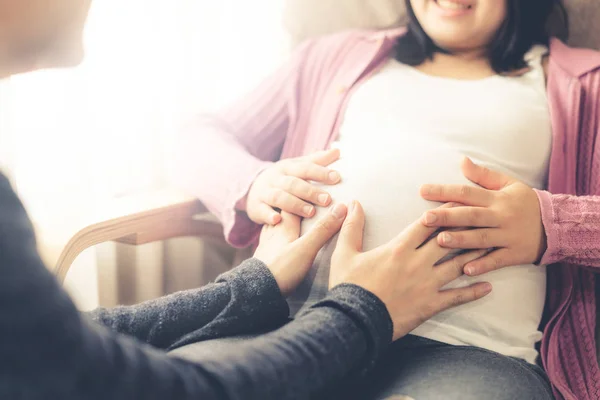 Pregnant couple feels love and relax at home.