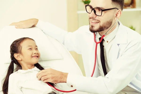 Médico examinando pequeño niño feliz en el hospital . — Foto de Stock