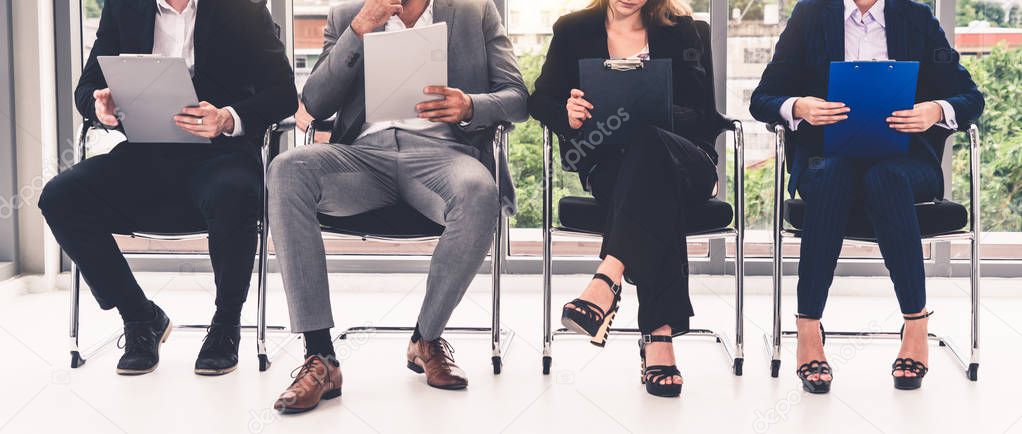 Businesswomen and businessmen wait for interview.