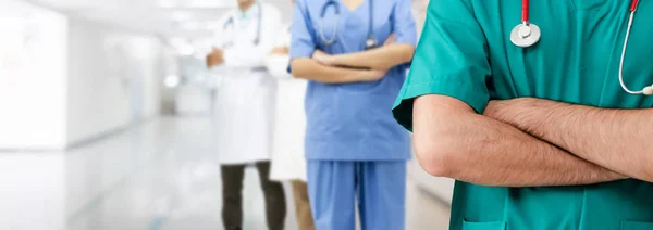 Doctor working in hospital with other doctors. — Stock Photo, Image