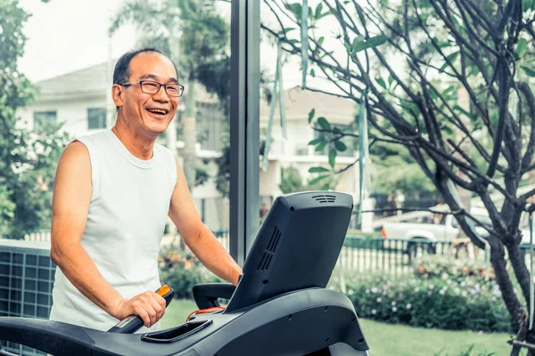 Senior man oefening op loopband in fitnesscentrum — Stockfoto