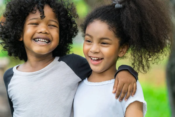 Happy little boy and girl in the park. — Stock Photo, Image