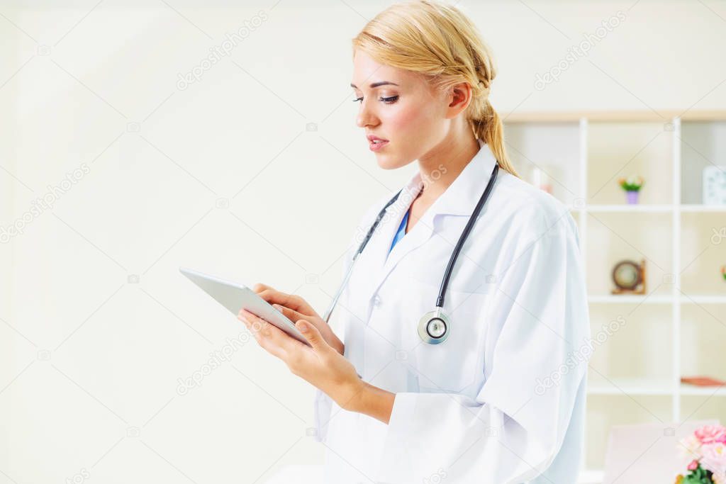 Young female doctor working in hospital office.