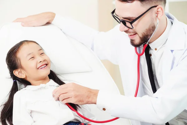 Médico examinando pequeño niño feliz en el hospital . — Foto de Stock