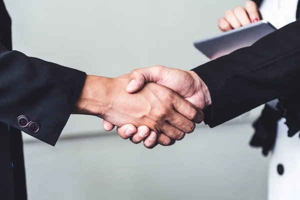 Business people handshake agreement in office.