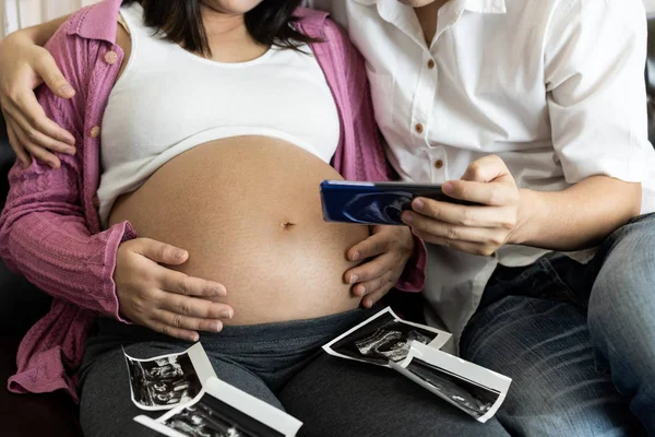 Pregnant couple feels love and relax at home.