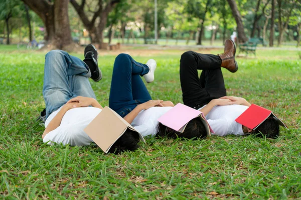 Funny students sleeping with books on their face.