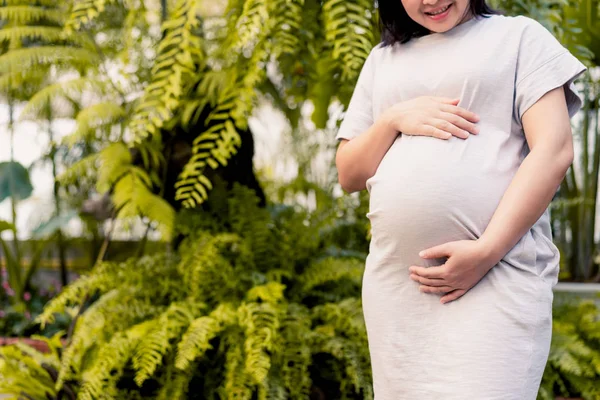 Happy pregnant woman and expecting baby at home.