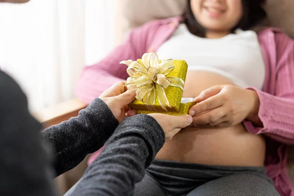 Pregnant couple feels love and relax at home.