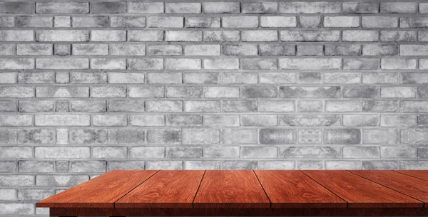 Wood table in front of brick wall blur background. — Stock Photo, Image