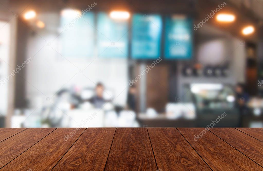 Wood table in blur background of modern restaurant