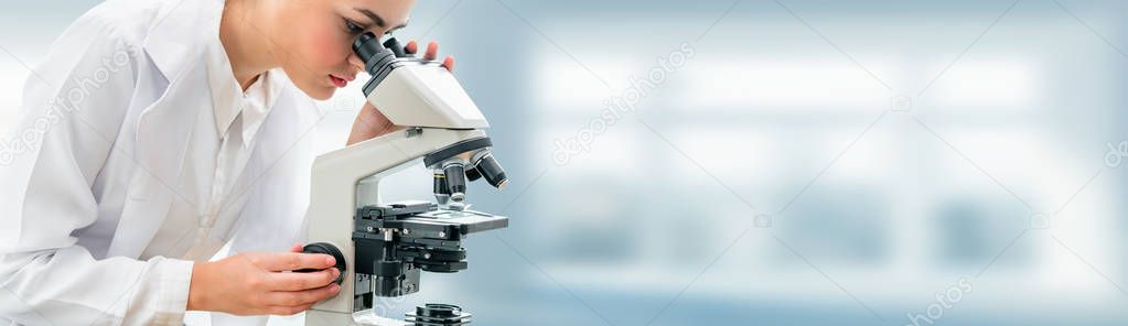 Scientist researcher uses microscope in laboratory