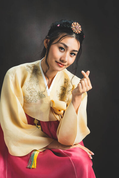Korean woman wearing traditional korean dress - Hanbok on black background in studio.