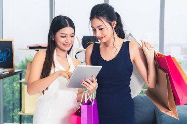 İki Asyalı kadın alışveriş merkezinde perakende mağazasında alışveriş. Modern ticaret yaşam tarzı.