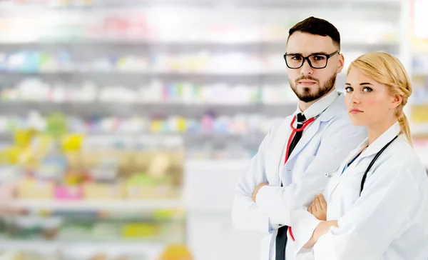 Pharmacist working with colleague in pharmacy.