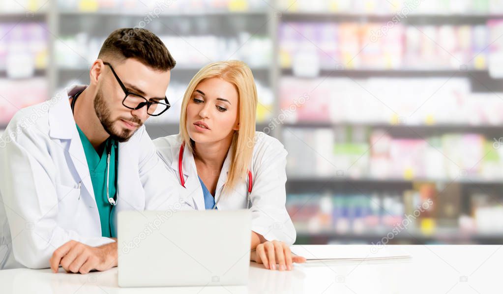 Pharmacist working with computer in pharmacy.