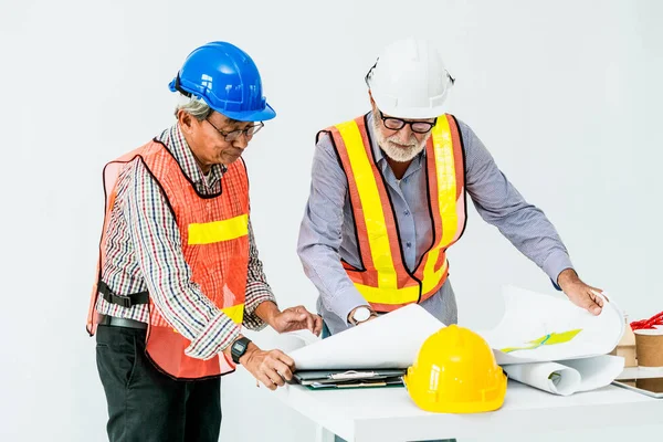 Senior engineer and architect working with drawing
