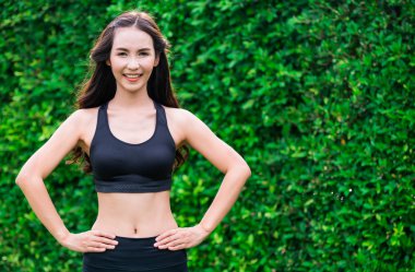 Genç spor kadını parkta sabah egzersizi yapıyor.