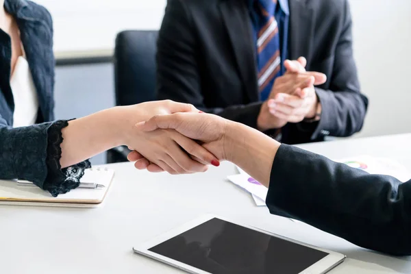 Business people handshake agreement in office.