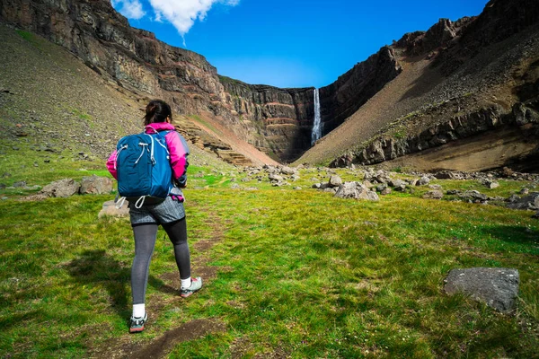 Caminhadas de viajantes em Hengifoss Waterfall, Islândia . — Fotografia de Stock