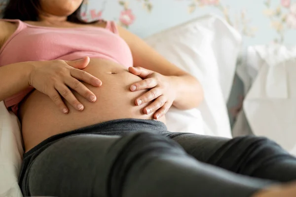 Mujer embarazada feliz y esperando un bebé en casa. — Foto de Stock