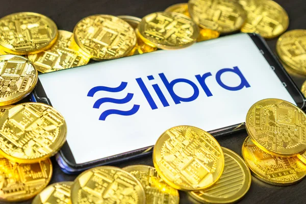Phone shows Libra logo on the screen.