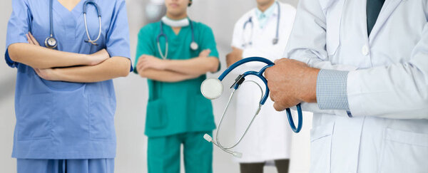 Doctor working in hospital with other doctors.