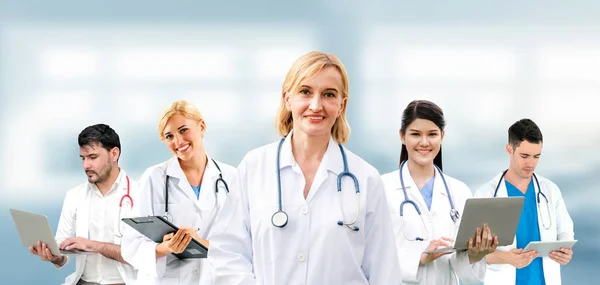 Doctor working in hospital with other doctors. Royalty Free Stock Images