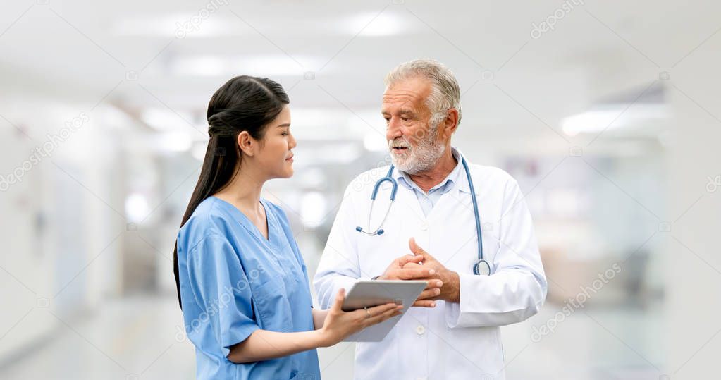 Senior and young doctor working in the hospital.