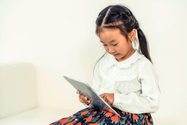 Tablet ile beyaz arka plan üzerinde küçük çocuk.