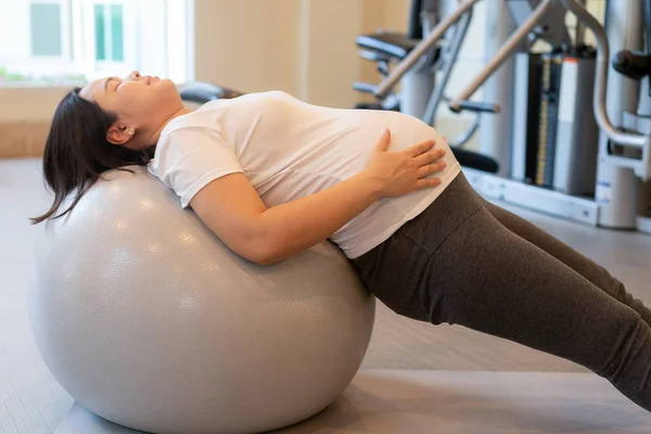 Aktivní těhotné ženy cvičení ve fitness centru. — Stock fotografie