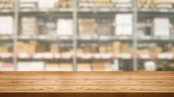 Wood table in warehouse storage blur background.